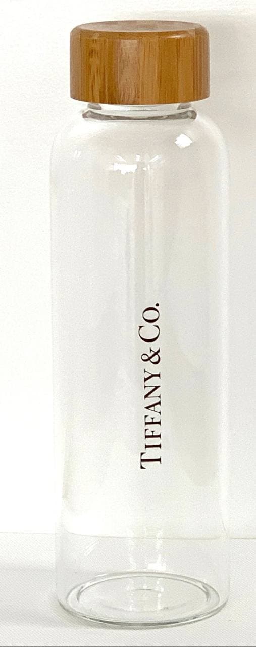 Glass drink bottle with bamboo cap and Tiffany & Co. wordmark — designed and made by Sense2.